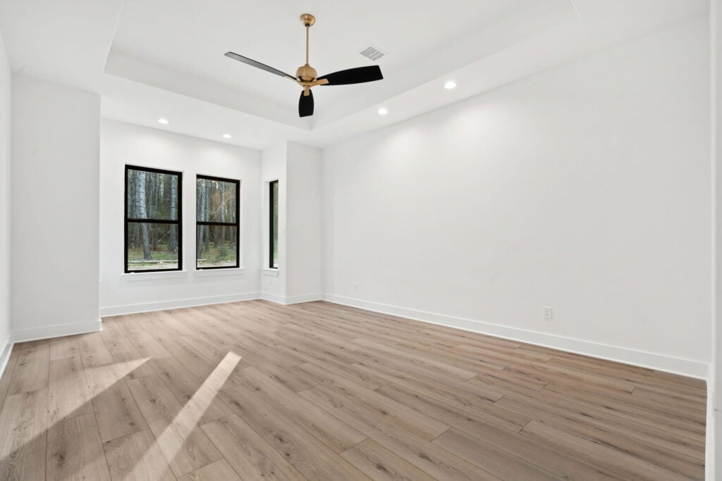 Bedroom with ceiling fan and natural light